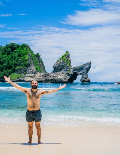 Man pose at Atuh Beach, Nusa Penida – Bali Tour Legendary